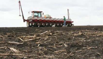 A fertilizer driving through a field.