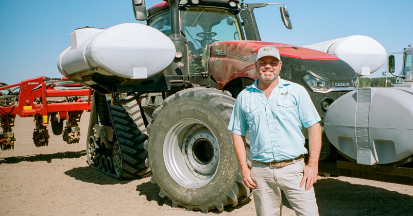 Heath Cutrell standing in front of a tractor.
