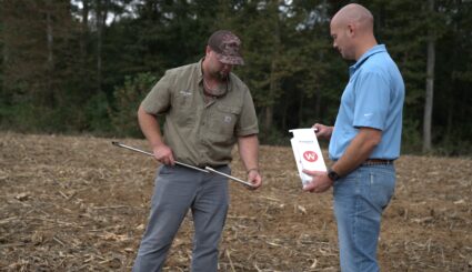 Pulling a soil sample for biological soil testing.